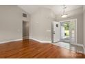 Inviting living room with gleaming hardwood floors, neutral paint, and a bright entry area at 2412 Laura Dr, Charlotte, NC 28212