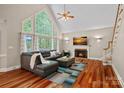 Spacious living room with hardwood floors, fireplace, and large windows, and modern furnishings at 3124 Lakewood Edge Dr, Charlotte, NC 28269