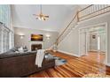 Open living space with hardwood floors, fireplace, and staircase in a modern setting at 3124 Lakewood Edge Dr, Charlotte, NC 28269
