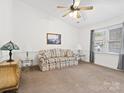 Spacious living room featuring plush carpeting, a ceiling fan, and tasteful decor creating a cozy atmosphere at 3164 Devonshire Dr, Rock Hill, SC 29732