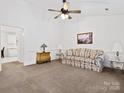 Spacious living room featuring plush carpeting, a ceiling fan, and tasteful decor creating a cozy atmosphere at 3164 Devonshire Dr, Rock Hill, SC 29732