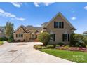 Beautiful brick home with manicured landscaping and a circular driveway at 3507 Governors Island Dr, Denver, NC 28037