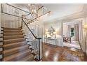 Bright foyer featuring a grand staircase, hardwood floors, and elegant decor at 3950 Abingdon Rd, Charlotte, NC 28211