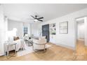 Bright living room with fireplace, light wood floors, and neutral color palette at 415 Lakewood Ave, Charlotte, NC 28208