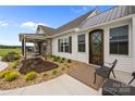 Welcoming front porch with stone accents, cozy seating, and a beautiful water feature, enhancing curb appeal at 4316 Nesbit Rd, Monroe, NC 28112