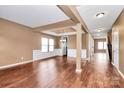 Spacious living room with neutral walls, wood floors, and a tray ceiling adding architectural interest at 5146 Elementary View Dr, Charlotte, NC 28269