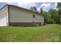 The back exterior features a brick foundation and well maintained siding, offering a clean and classic look at 5817 Wingate Hill Rd, Denver, NC 28037
