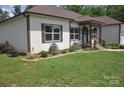 Beautifully landscaped front yard with colorful flower beds and a well-manicured lawn enhances the home's curb appeal at 5817 Wingate Hill Rd, Denver, NC 28037