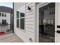 Balcony area featuring white siding and a view of neighboring houses on a sunny day at 6005 Countess Dr # 49, Charlotte, NC 28217