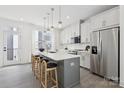Bright kitchen with a center island, stylish seating, stainless steel appliances, and white cabinets at 6005 Countess Dr # 49, Charlotte, NC 28217