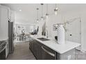 Modern kitchen featuring a large island with pendant lighting, stainless steel appliances, and an open floor plan at 6005 Countess Dr # 49, Charlotte, NC 28217