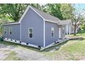 Charming gray house with a well-maintained lawn, showcasing the property's curb appeal at 703 S Main St, Landis, NC 28088
