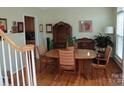 Bright dining room with hardwood floors, a large window, and classic furnishings at 7321 Harrisonwoods Pl, Charlotte, NC 28270