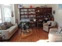 Cozy living room features hardwood floors, comfortable seating, and built-in bookshelves at 7321 Harrisonwoods Pl, Charlotte, NC 28270