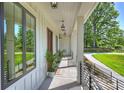 Charming covered porch with wood-paneled walls and elegant lighting, perfect for relaxing outdoors at 7768 Lynwood Ln, Sherrills Ford, NC 28673