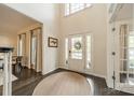 Bright foyer features a tall ceiling, a welcoming front door, and elegant rug at 8902 Whittingham Dr, Waxhaw, NC 28173