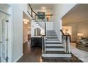 Elegant foyer with a staircase, dark hardwood floors, and stylish decor at 8902 Whittingham Dr, Waxhaw, NC 28173