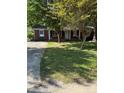Traditional brick house with a covered front porch and well-maintained lawn at 918 Carmel Dr, Gastonia, NC 28056