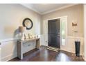 Foyer with dark hardwood flooring, black door, and stylish decor at 924 Forbes Rd, Fort Mill, SC 29707