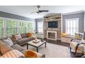 Comfortable living room with a fireplace, built-in shelving, and natural lighting at 924 Forbes Rd, Fort Mill, SC 29707