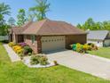 Lovely brick home with an attached garage and landscaped front yard at 1005 Spring Rock Dr, Salisbury, NC 28146