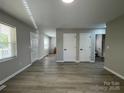 Spacious living room with new floors, bright natural light, neutral walls, and convenient closet space at 113 Burke Cir, Mooresville, NC 28115