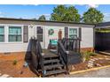 Charming front porch with dark wood stairs, decorative accents, and a cozy seating area at 114 Doubletree Dr, Statesville, NC 28677