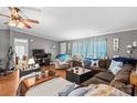 Spacious living room with a large sectional sofa, nautical decor, and warm, inviting ambiance at 114 Doubletree Dr, Statesville, NC 28677