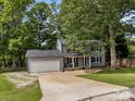 Charming two-story home with a covered front porch, an attached garage, and a lush green lawn at 130 Cherokee Ln, Salisbury, NC 28147