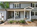 Cozy covered front porch with seating, complemented by landscaping, and a welcoming entrance at 130 Cherokee Ln, Salisbury, NC 28147
