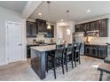 Modern kitchen with a large island, stainless steel appliances, granite countertops, and dark cabinetry at 1607 Tundra Ln, Denver, NC 28037