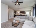 Bright, open-concept living space with an inviting sectional couch and views into the modern kitchen at 1607 Tundra Ln, Denver, NC 28037