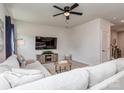 Comfortable living room with a modern ceiling fan, plush sectional sofa, and contemporary decor at 1607 Tundra Ln, Denver, NC 28037