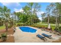 Aerial view of backyard pool with lounge chairs, lush landscaping and privacy fence at 172 Fairway Cir, Rock Hill, SC 29730