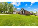 Expansive well-maintained yard that surrounds this beautiful brick home with a detached shed at 201 Churchill Dr, Kings Mountain, NC 28086
