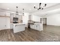 This spacious kitchen features gray cabinets, stainless steel appliances, quartz countertops and hardwood floors at 2311 Bulwarks Ct # 3P, Albemarle, NC 28001