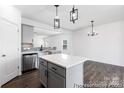 Kitchen island with stainless steel appliances, gray cabinets, quartz countertops and hardwood floors at 2311 Bulwarks Ct # 3P, Albemarle, NC 28001