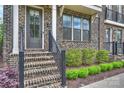 Inviting front entrance with brick steps, black railing, and meticulously maintained landscaping leading to the front door at 2541 Kenmore Ave, Charlotte, NC 28204