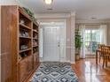 Welcoming foyer with hardwood floors, decorative rug, and a built-in bookcase at 2603 Willis Dr, Harrisburg, NC 28075