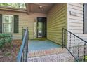 Close up of the front entrance with brick steps, black railing, and covered porch area at 2710 Red Bud Ln, Fort Mill, SC 29715