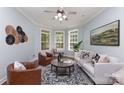 Bright living room with bay windows, hardwood floors, neutral paint, and elegant furnishings at 3004 Point Clear Dr, Tega Cay, SC 29708