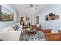 Inviting living room flowing into dining area, featuring hardwood floors and stylish decor at 3004 Point Clear Dr, Tega Cay, SC 29708