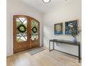 Bright foyer showcasing wooden double doors, light hardwood floors, and stylish wall decor at 3505 Trent St, Charlotte, NC 28209