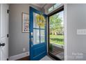 Open front door with blue trim and a view of the landscaped front yard at 413 Nobles Way, Belmont, NC 28012