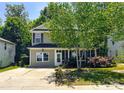 Charming two-story home with a welcoming front porch and well-maintained landscaping at 4825 Samuel Richard St, Kannapolis, NC 28083