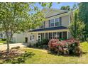 Charming two-story home with a welcoming front porch and well-maintained landscaping at 4825 Samuel Richard St, Kannapolis, NC 28083
