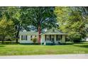 Cozy home with light yellow siding, complemented by a green roof and tidy front yard at 495&501 Turnersburg Hwy, Statesville, NC 28625