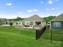 Expansive backyard featuring a stone patio, fenced-in area, and beautifully maintained lawn at 5058 Antebellum Dr, Iron Station, NC 28080