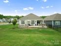 Spacious backyard with patio, stone accents, perfect for outdoor living and entertaining at 5058 Antebellum Dr, Iron Station, NC 28080