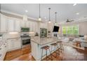 Modern kitchen with granite countertops, stainless steel appliances, and a breakfast bar at 5210 Valley Stream Rd, Charlotte, NC 28209